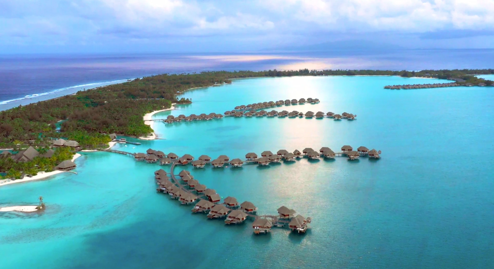 Maldives resort villas over clear blue water